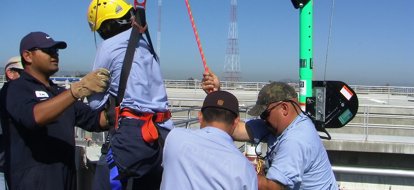 3 men participating in safety training exercise